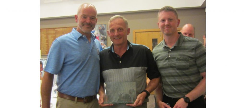 Brown and Ralph golf team collecting the award