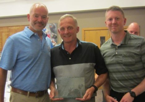 Brown and Ralph golf team collecting the award